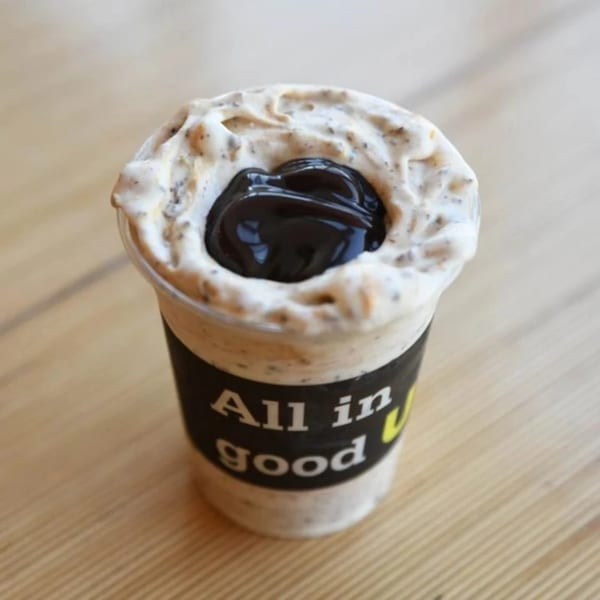 Unforked's "All in good" milkshake, topped with whipped cream and a dark chocolate swirl.