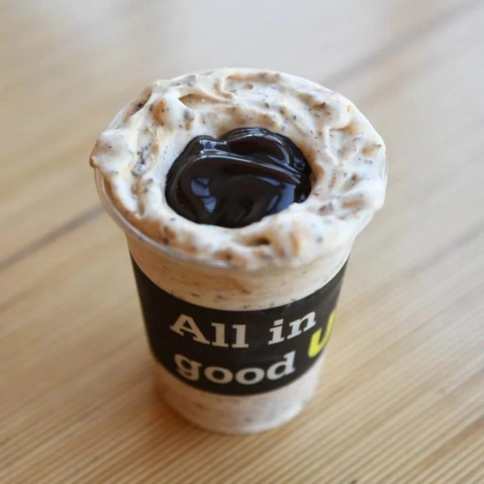 Unforked's "All in good" milkshake, topped with whipped cream and a dark chocolate swirl.